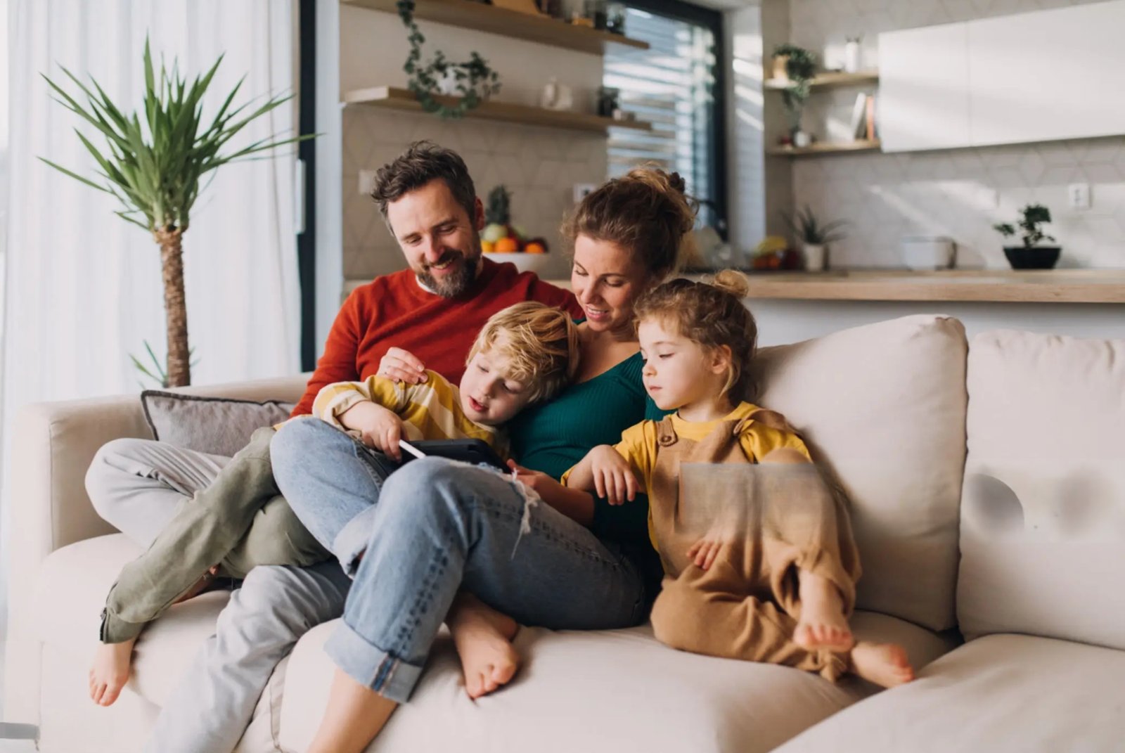 A young Australian family with two kids enjoying breakfast at the kitchen table